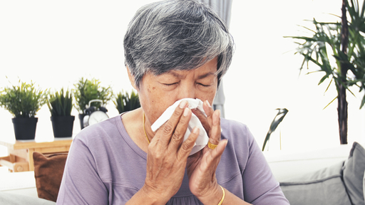 asian-mature-woman-with-allergy-sneezing-and-blowi